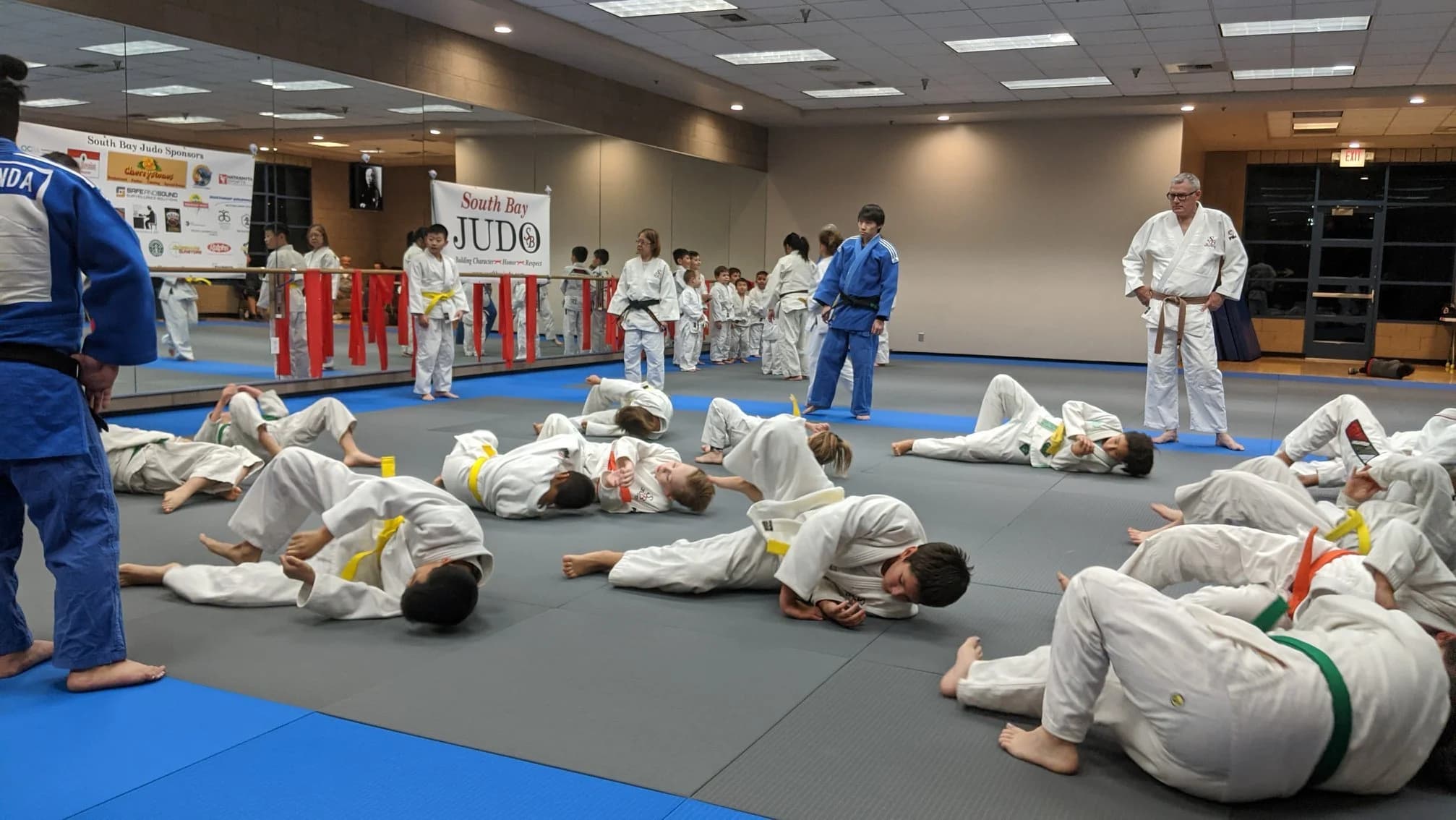 South Bay Judo students practicing groundwork with instructors at Wilson Park