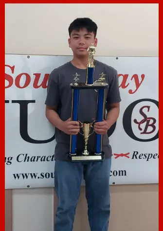 Zachary Ordinario holding his 2025 South Bay Judo award